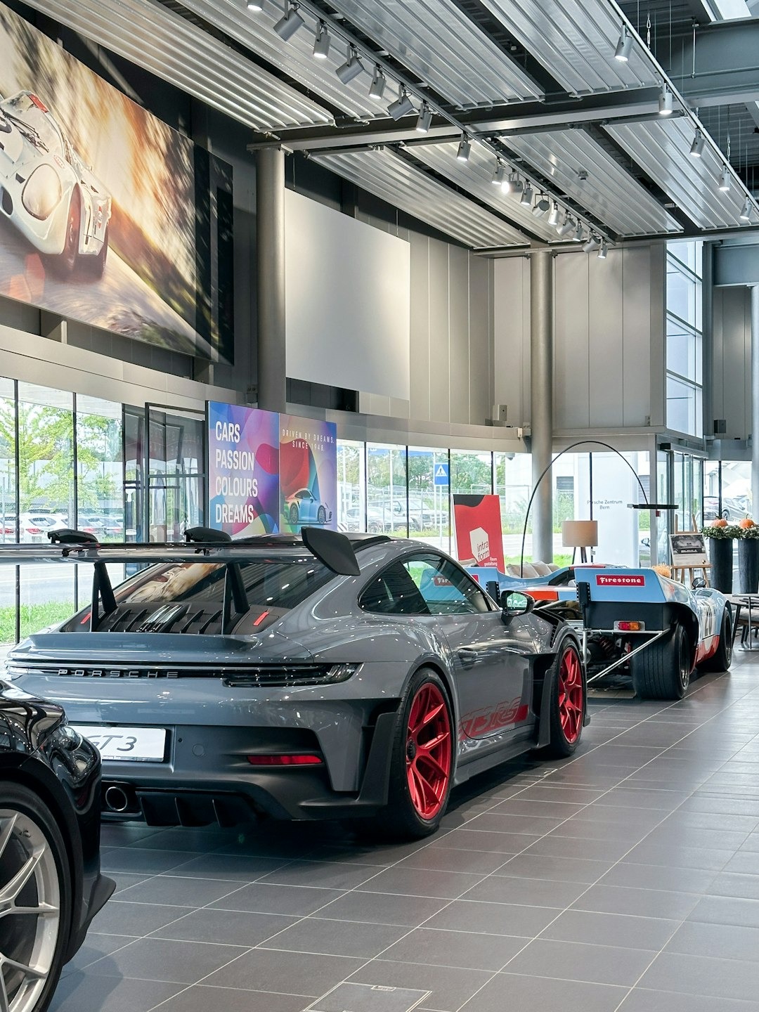 New cars for sale in a bright, modern dealership showroom.